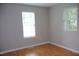 This bedroom has blonde floors, fresh paint, and two windows that bring in a lot of natural light at 1536 Granville Street, Burlington, NC 27215