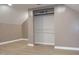 Closet featuring a slanted ceiling, built-in shelving, and light walls and floors at 1536 Granville Street, Burlington, NC 27215