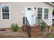 The front entry features brick steps with metal railings and a white front door surrounded by symmetrical windows at 1536 Granville Street, Burlington, NC 27215