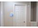 Hallway featuring neutral paint, smart thermostat, views into other rooms, and a white door at 1536 Granville Street, Burlington, NC 27215