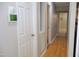 Hallway featuring blonde floors, fresh paint, digital thermostat, and views into other rooms at 1536 Granville Street, Burlington, NC 27215