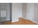 Hallway featuring blonde floors, fresh paint, built in shelves, and two doors at 1536 Granville Street, Burlington, NC 27215