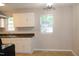 Bright kitchen with white cabinets, a stainless steel sink, and a modern light fixture at 1536 Granville Street, Burlington, NC 27215