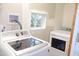 Laundry room with new front loading washer and dryer and a window that looks outside at 1536 Granville Street, Burlington, NC 27215