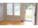 Bright living room featuring blonde floors and an open doorway with natural light coming through white windows at 1536 Granville Street, Burlington, NC 27215