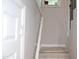 Staircase with a white handrail and a potted plant on the window at 1536 Granville Street, Burlington, NC 27215