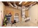 Unfinished basement with HVAC equipment, utility connections, and exposed beams at 1536 Granville Street, Burlington, NC 27215