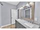 Stylish bathroom with double vanity, framed mirrors, modern lighting, and a glass-enclosed shower at 1702 Falls Church Rd, Raleigh, NC 27609
