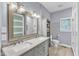 Stylish bathroom with double vanity, framed mirrors, modern lighting, and a glass-enclosed shower at 1702 Falls Church Rd, Raleigh, NC 27609