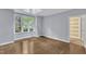 Well-lit bedroom with hardwood floors, skylight, and large windows offering lots of natural light at 1702 Falls Church Rd, Raleigh, NC 27609