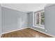 Bedroom with hardwood floor and window with view at 1702 Falls Church Rd, Raleigh, NC 27609