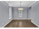 Traditional dining room features wood floors, a modern light fixture, and neutral paint at 1702 Falls Church Rd, Raleigh, NC 27609