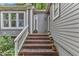 Close-up of home's entrance with charming brick steps and potted plants at 1702 Falls Church Rd, Raleigh, NC 27609