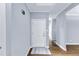 Bright foyer with hardwood floors and a white door at 1702 Falls Church Rd, Raleigh, NC 27609