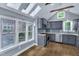 Eat-in kitchen is light and bright with stainless appliances, gray cabinets and beautiful skylights at 1702 Falls Church Rd, Raleigh, NC 27609