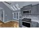 Bright eat-in kitchen features stainless appliances, hardwood floors, skylights and granite countertops at 1702 Falls Church Rd, Raleigh, NC 27609