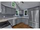 Beautifully renovated kitchen with modern appliances, gray cabinetry, and sleek countertops at 1702 Falls Church Rd, Raleigh, NC 27609