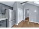 Updated kitchen boasts stainless appliances, white shaker cabinets and hardwood flooring at 1702 Falls Church Rd, Raleigh, NC 27609