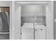 Laundry room in closet, next to kitchen, includes front loading washer and dryer at 1702 Falls Church Rd, Raleigh, NC 27609