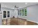 Bedroom with beautiful windows offering wooded views and a ceiling fan for energy efficiency at 1702 Falls Church Rd, Raleigh, NC 27609