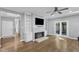 Inviting living room with fireplace, built-ins and access to the outdoor living space at 1702 Falls Church Rd, Raleigh, NC 27609