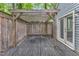 Private patio with wood pergola and fenced in area at 1702 Falls Church Rd, Raleigh, NC 27609