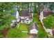 Aerial view of a landscaped property with a two-story home, boat, cars, and a detached garage at 1724 Briarforest Pl, Raleigh, NC 27615