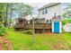 Backyard with multi-tiered wood decks, grassy yard, and surrounded by mature trees at 1724 Briarforest Pl, Raleigh, NC 27615