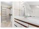 En-suite bathroom has a vanity with drawers, a large mirror, and a walk in closet at 1724 Briarforest Pl, Raleigh, NC 27615