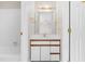 This is a view into the connected bathroom with white cabinets and countertops at 1724 Briarforest Pl, Raleigh, NC 27615