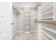 Walk-in closet with built-in shelving and hanging rods, providing ample storage at 1724 Briarforest Pl, Raleigh, NC 27615