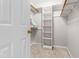 Walk-in closet with carpet and shelving, offering ample storage space for clothes and accessories at 1724 Briarforest Pl, Raleigh, NC 27615