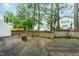 A view of the multi-tiered wood deck which overlooks the grassy backyard at 1724 Briarforest Pl, Raleigh, NC 27615