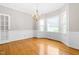 Formal dining room featuring a chandelier, hardwood floors, and bright bay windows at 1724 Briarforest Pl, Raleigh, NC 27615