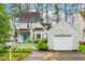 Charming two-story home with a blue front door, white picket fence and a detached single-car garage at 1724 Briarforest Pl, Raleigh, NC 27615
