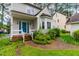 Close up of front entrance with brick steps, blue door and surrounding landscaped garden at 1724 Briarforest Pl, Raleigh, NC 27615
