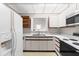 Bright kitchen featuring white appliances, cabinets, and countertops, creating a clean, functional space at 1724 Briarforest Pl, Raleigh, NC 27615