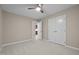 Neutral bedroom features a ceiling fan, plush carpet, and a double door closet at 173 Clancy Cir, Cary, NC 27511