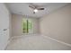 A clean, carpeted bedroom features a window view and closet at 173 Clancy Cir, Cary, NC 27511