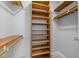 Empty walk-in closet with custom built-in wooden shelves at 173 Clancy Cir, Cary, NC 27511