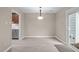 Bright dining room with modern flooring, a contemporary light fixture, and a sliding door leading to the outdoor area at 173 Clancy Cir, Cary, NC 27511