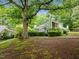 View of the house with trees and landscaping at 173 Clancy Cir, Cary, NC 27511