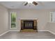 Cozy living room featuring a brick fireplace, modern floors, and windows offering a tranquil view at 173 Clancy Cir, Cary, NC 27511