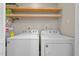 A well-lit laundry room featuring a washer and dryer and water heater at 173 Clancy Cir, Cary, NC 27511