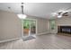 Bright living room with modern flooring, fireplace, ceiling fan, and sliding glass door leading to outdoor space at 173 Clancy Cir, Cary, NC 27511