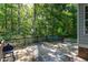 Spacious back deck with outdoor seating, grill and scenic views of the surrounding wooded area at 175 Fox Run Rd, Youngsville, NC 27596