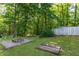Landscaped backyard showcasing a fire pit and storage shed, perfect for relaxation and outdoor storage at 175 Fox Run Rd, Youngsville, NC 27596