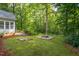 Expansive backyard featuring a patio, fire pit, and lush green space ideal for outdoor enjoyment and gatherings at 175 Fox Run Rd, Youngsville, NC 27596