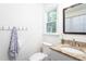 Bathroom with a granite countertop, a window, and decorative towel rack at 175 Fox Run Rd, Youngsville, NC 27596