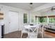 Bright breakfast nook with white table and chairs, opening to the living room at 175 Fox Run Rd, Youngsville, NC 27596